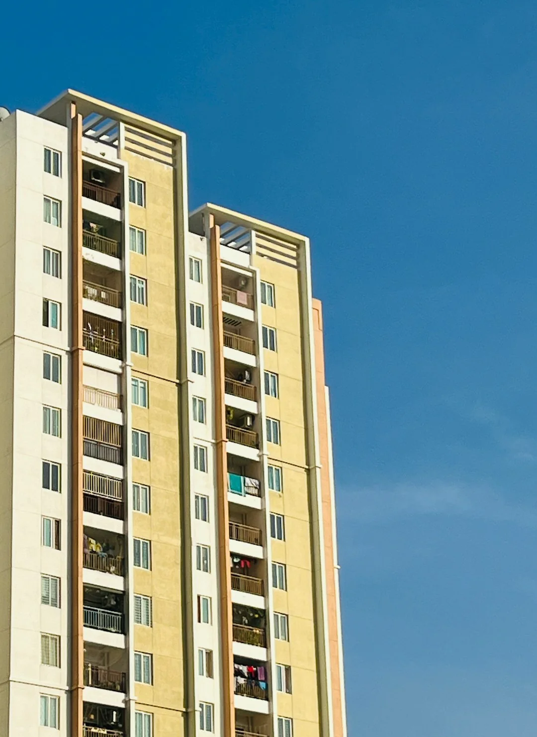 High-rise glass facade with suspended platform for window cleaning.
